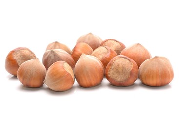Heap of hazelnuts on white background