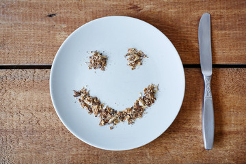 smiley face out of breadcrumbs on white table