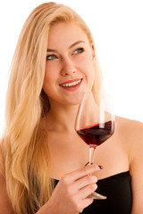 Cute blonde woman drinks a glass of red wine isolated over white