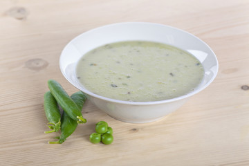 Pea vegetable soup bowl on wooden table