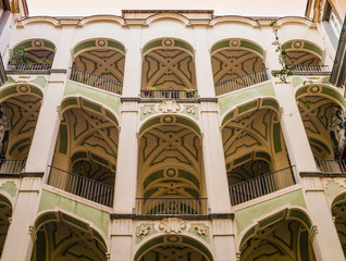 Scenographic courtyard staircases of Palazzo dello Spagnuolo, Rione Sanità, Naples, Italy
