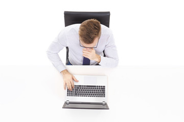 Overhead view of a handsome businessman working in office on a laptop. Business and office concept