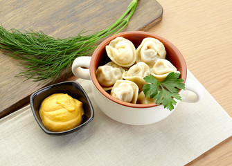 Russian dumplings - pelmeni, in white bowl