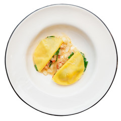 Ravioli-like dish with crayfish, apples and herbs isolated on wh
