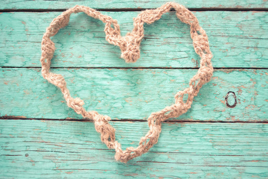 Heart of rope on a wooden background