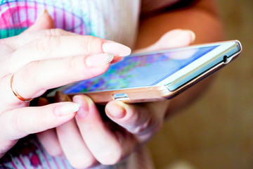 Woman hand holding smartphone and typing SMS
