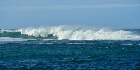 Crashing waves on breakwater in a stormy windy day.