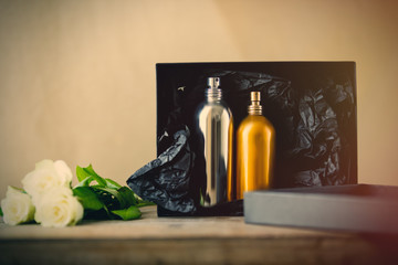 erfumes and roses on wooden table