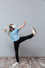 Vertical image of Woman in shirt using virtual reality device