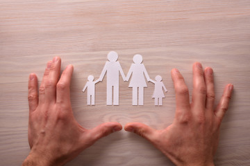 Fototapeta na wymiar Concept of family protection with hands upside down