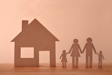 Concept of house and family in paper on wood front