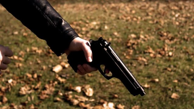 Female Secret Agent raises pistol to object off camera   Action Movie Shots