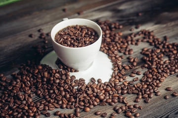 Coffee beans in a cup and an inverted saucer