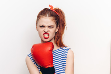 woman in boxing gloves and in a striped T-shirt, grinning