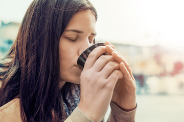 Close up of woman drinking coffee in a cafe