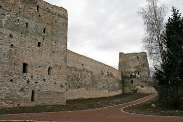 Fototapeta na wymiar The stony defensive wall between the towers of Izborsk fortress, Pskov region, Russia