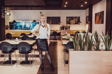 Slim young model posing for camera. Beautiful long slender legs of the model