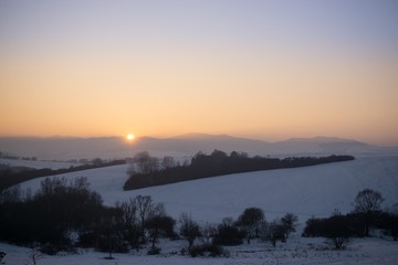 Sunset on meadow with snow during winter. Slovakia