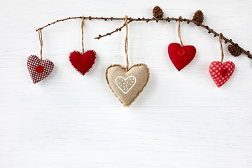 Valentine Day background. Colorful hearts on white wooden background. Copy space