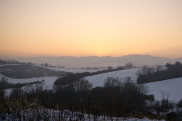 Sunset on meadow with snow during winter. Slovakia
