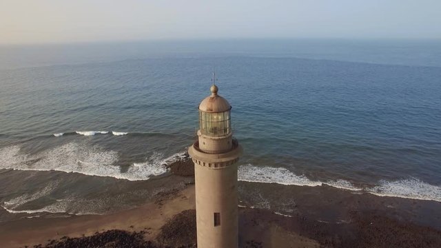 Aerial shot of the ocean and Maspalomas Lighthouse of 19th century on the coast of Gran Canaria