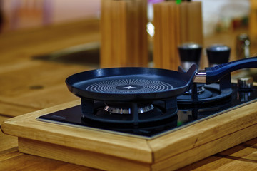pan on a gas stove in modern kitchen.
