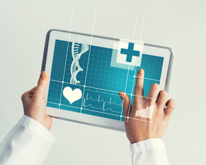 Close of female doctor hands working with tablet pc computer