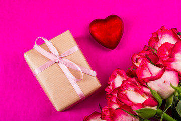 pink roses and a gift on a purple background
