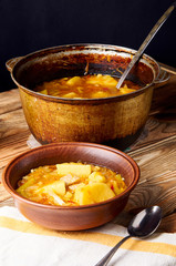 Traditional soup from Bolivia / America. Simple home cooking. A pot with a delicious hot meat soup. Table served for dinner. Delicious American, European and Asian cuisine.