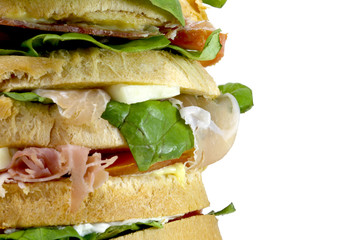 giant sandwich stuffed with many layers of bread with lettuce to