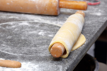 Baker kneading dough in a bakery