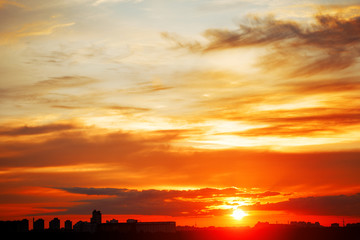 Naklejka premium Sunrise in city landscape. Urban sunset. Rays of the sun above t