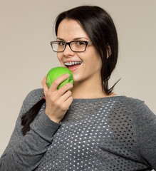 Nerd girl in glasses and with brackets on teeth. Positive, excellent student woman hipster.