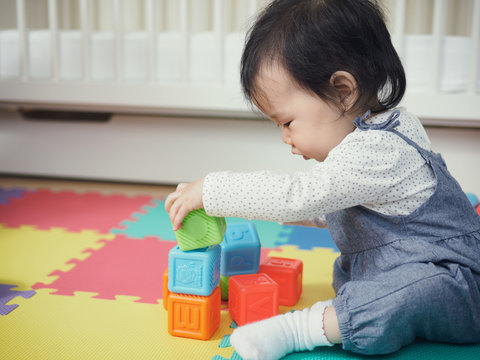 Cute baby girl playing  toys at home
