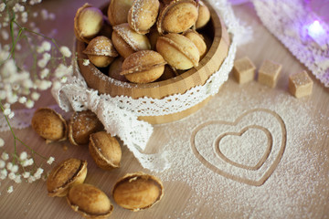 Homemade nuts cookies on old wooden table. Holiday decoration ho