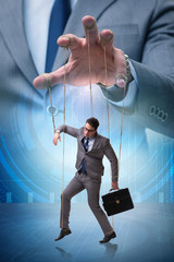 Businessman puppet being manipulated by boss