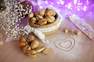 Homemade nuts cookies on old wooden table. Holiday decoration ho