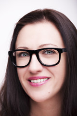 Fototapeta premium Beautiful young woman wearing glasses close-up isolated on white