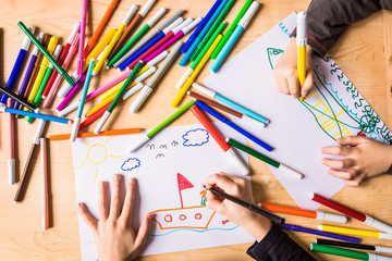 Kids drawing with colored marking pens 