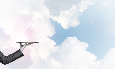 Waiter holding empty silver platter ready for product or item placement