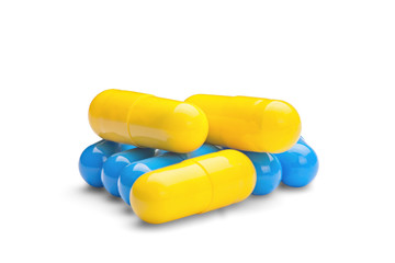 medicine yellow and blue pills on a isolated white background