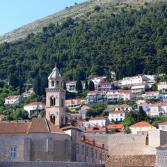 Fototapeta na wymiar Dominican monastery and bell tower, landmark in Dubrovnik, Croatia. Old Town Dubrovnik is popular tourist destination and UNESCO World Heritage Site. 