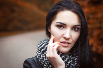 girl in black leather jacket and knitted striped scarf