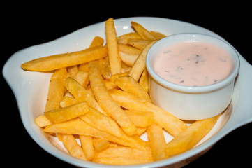 French fries with sauce on a white plate