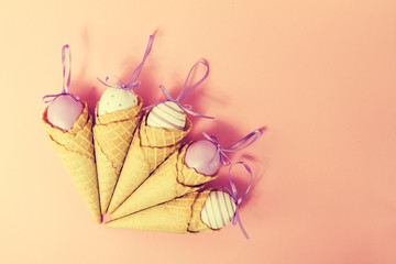 Colorful Ice Cream Cones with Easter Eggs on Pink Background. Va