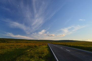 Open road no traffic at dusk to horizon summer evening sky