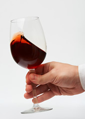 Man hand with red wine glass