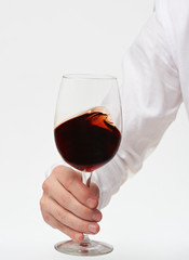Hand holding red wine glass