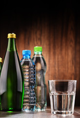 Composition with glass and bottles of mineral water