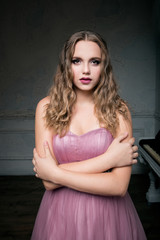 portrait of young beautiful girl in long pink dress